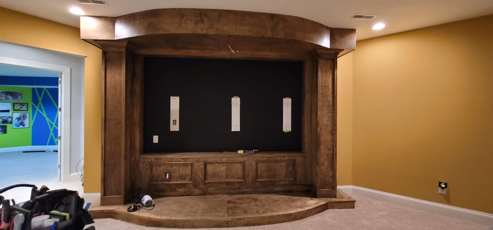 Noble A-V home theater installation in progress with projector screen and acoustic-treated walls