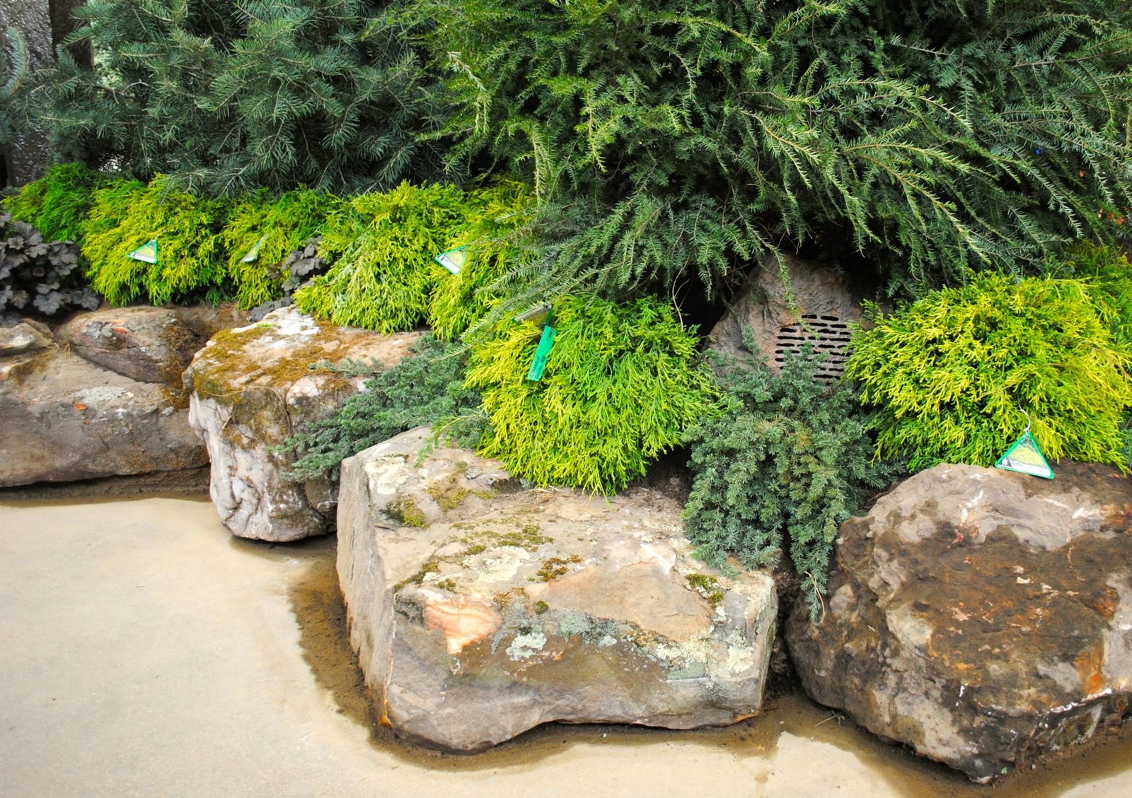 Outdoor audio system featuring rock-look landscape speakers and screens at the Indianapolis Flower & Patio Show by Noble A-V