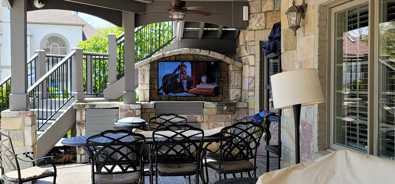 Television installed under a covered patio for outdoor entertainment