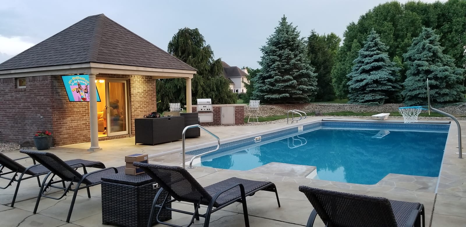 Poolside outdoor television on a motorized mount installed by Noble A-V