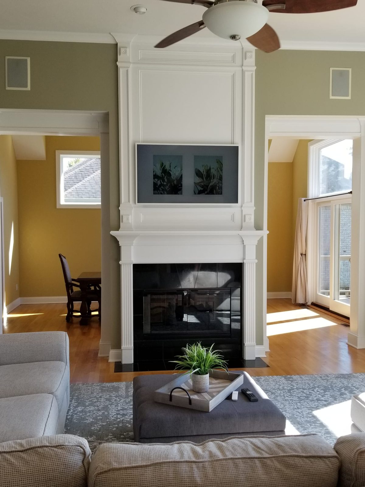 Samsung Frame television mounted over a fireplace, displaying art when not in use
