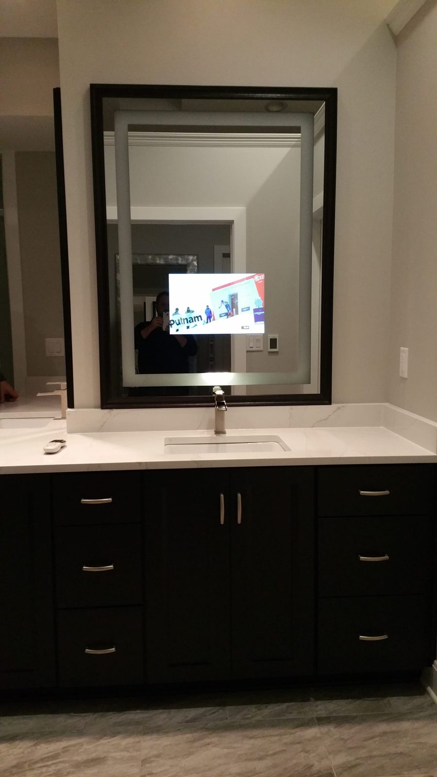 Séura mirror television integrated into a luxury bathroom, appears as a mirror when off