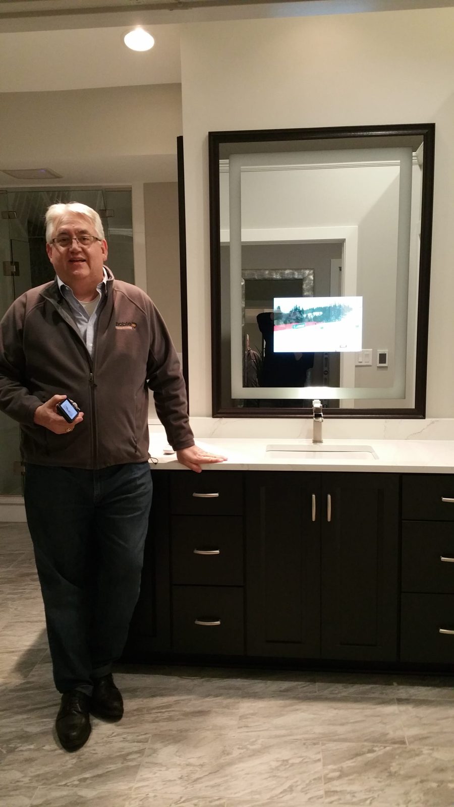 Séura mirror TV showing image content while installed above bathroom vanity