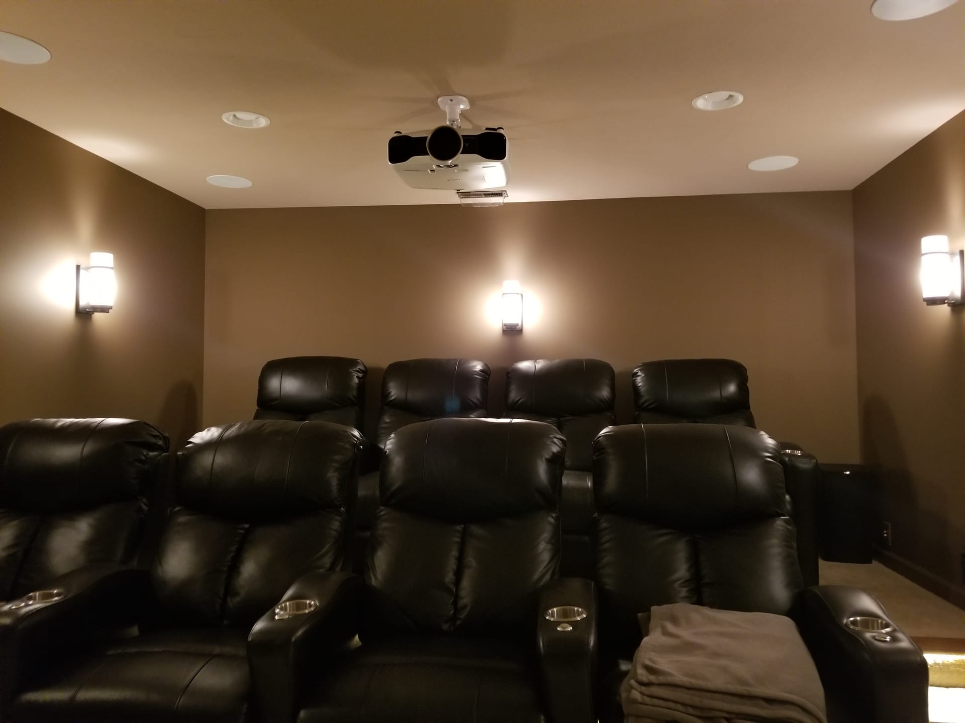 Tiered theater-style seating in a custom Noble A-V home theater installation