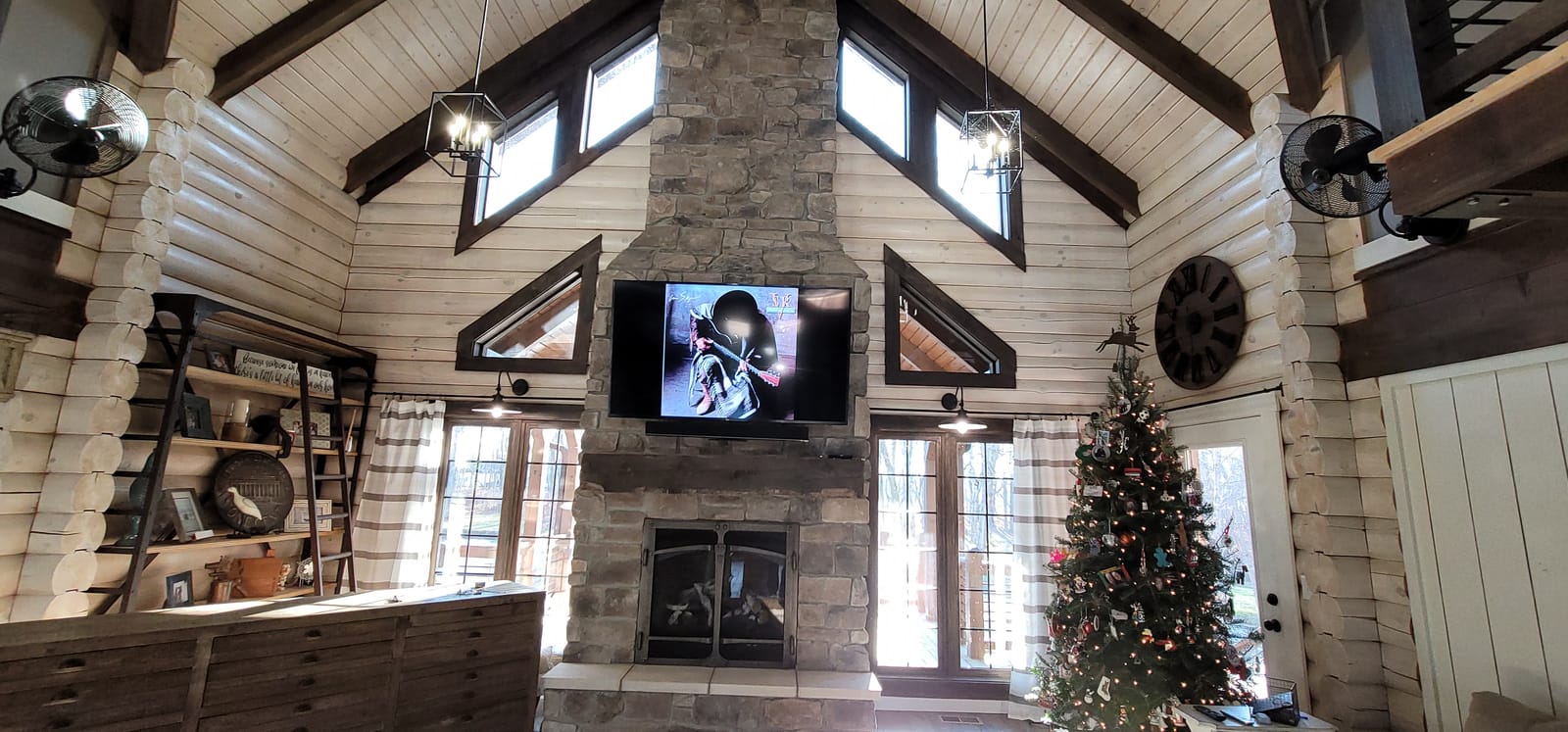 Television installed on a Mantle Mount system above a traditional fireplace mantle