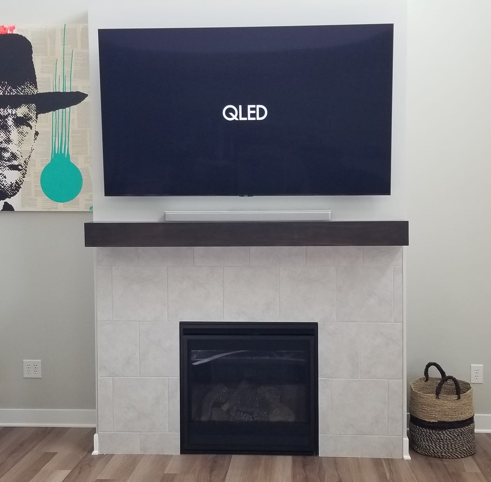 Television installed above fireplace, alternate view of the same Noble A-V installation